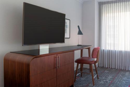 a room with a desk with a television on top of it at Le Meridien Washington, DC, The Madison in Washington