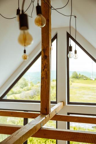 a room with a large window in a house at Sunset Hills Chalet in Slănic