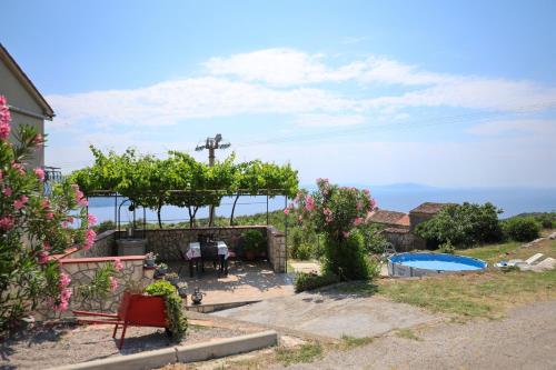 a house with a garden and a swimming pool at Apartman Fonovici in Juraši