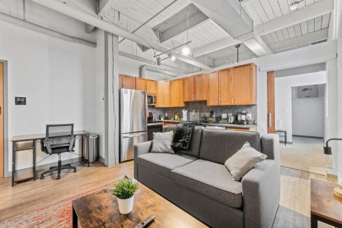 a living room with a couch and a table at Downtown Loft l Cleveland l Parking l Cafe in Cleveland
