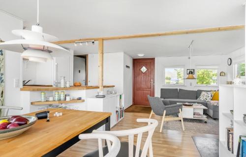 a kitchen and living room with a table and chairs at Awesome Home In Munkebo With Wifi in Munkebo
