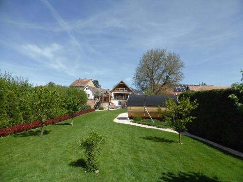 a yard with trees and a house in the background at Beck's Borveranda Palkonya in Palkonya