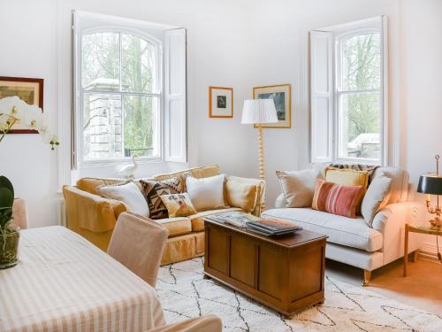 a living room with two couches and a table at West Lodge in Barnard Castle