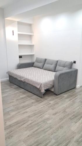 a bedroom with a bed in a white room at Air-Moldova Family in Chişinău