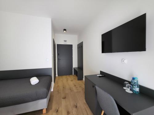 a living room with a couch and a flat screen tv at W64 Apartamenty in Płock