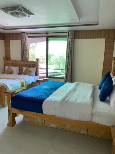Postel nebo postele na pokoji v ubytování Arcadian Resort Skardu