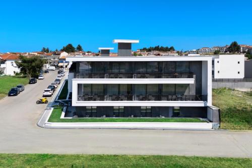 an external view of a building with a parking lot at Bareti Boutique Estate in Kallithea Halkidikis