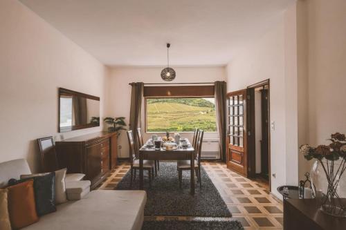 a living room with a table and a couch at Douro Panorama Valley in Pinhão