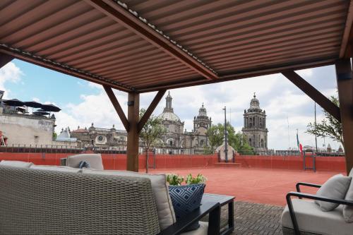 a view of a building from a patio with chairs at CASA SAUTO 2 BR 2BA balcony Historic Building in Mexico City