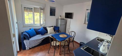 a small room with a bed and a table and chairs at Apartments Villa Andreja in Starigrad