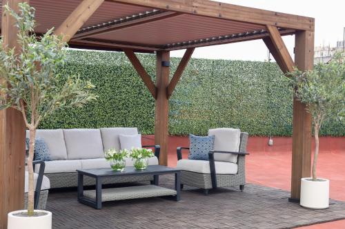 a wooden pergola with two chairs and a table at CASA SAUTO 2 BR 2BA balcony Historic Building in Mexico City