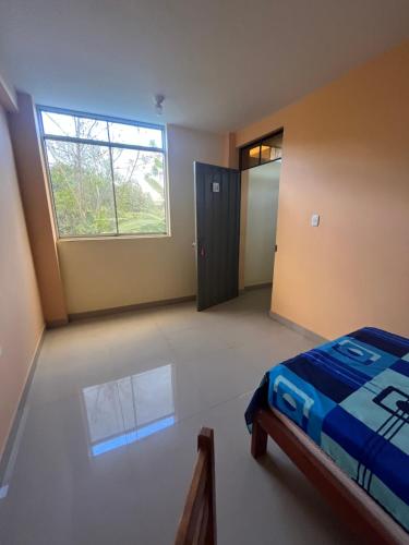 a bedroom with a bed and a window and a door at Zzi in Lamas