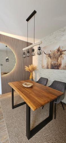 a dining room with a wooden table and two chairs at Home sweet Home in Havelberg