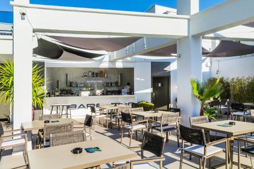 a restaurant with tables and chairs and a bar at Bareti Boutique Estate in Kallithea Halkidikis