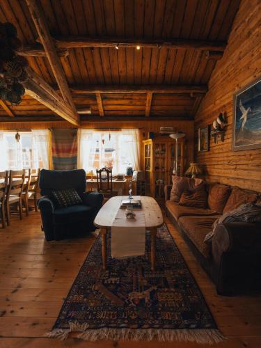 a living room with a couch and a coffee table at Arctic Fishermans Lodge- SAUNA included in Moskenes