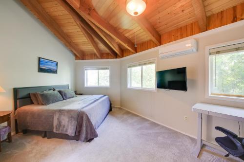 a bedroom with a bed and a flat screen tv at Stellar Views! Lake Pend Oreille Retreat with Dock in Sagle