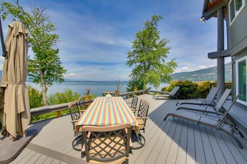 a table and chairs on a deck with a view of the water at Stellar Views! Lake Pend Oreille Retreat with Dock in Sagle