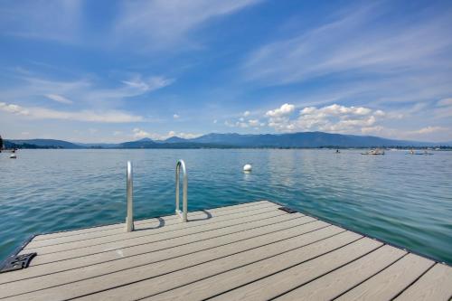 a dock on a lake with mountains in the background at Stellar Views! Lake Pend Oreille Retreat with Dock in Sagle