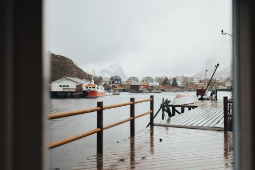 a view of a dock with a boat in the water at Arctic Fishermans Lodge- SAUNA included in Moskenes