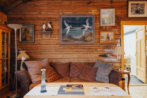 a living room with a couch and a table at Arctic Fishermans Lodge- SAUNA included in Moskenes