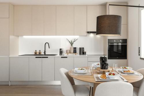 ペニシェにあるCasa de S Pedroのキッチン(木製テーブル、白いキャビネット付)