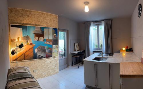 a kitchen with a large aquarium in the wall at JR HOME Apuania in Massa