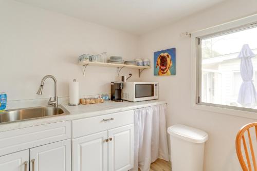 a kitchen with a sink and a microwave at Walk to Norfork Lake Guest House in Henderson in Henderson