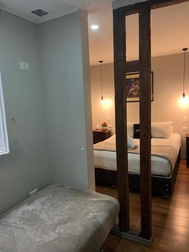 a bedroom with two beds and a mirror at BbCasita Blue in Santiago