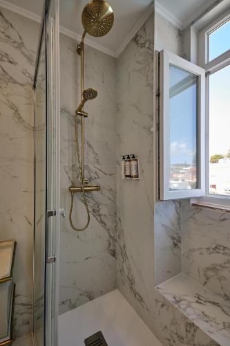 a bathroom with a shower with a glass door at Casal Santa Virginia in Sintra