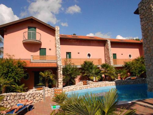 a person laying in a chair in front of a house at Holiday Homes in Lignano 21665 in Lignano Sabbiadoro