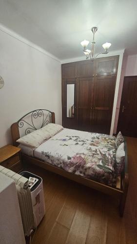 a bedroom with a bed and a dresser at Casa dos trevos in Pataias
