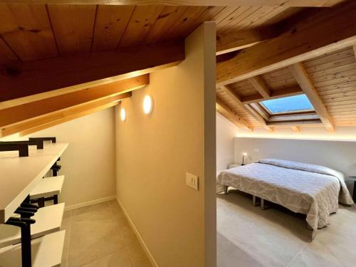 a bedroom with a bed in a room with wooden ceilings at Holiday Homes in Lignano 21665 in Lignano Sabbiadoro
