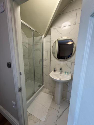 a bathroom with a shower and a sink and a mirror at Eurobar & Hotel in Oxford