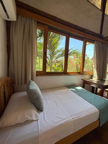 Una cama o camas en una habitación de Hostería Mandála