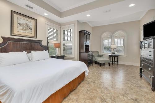 Un dormitorio con una cama grande y un escritorio. en Sea Gate #305, en Demere Park