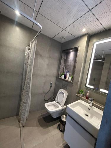 a bathroom with a toilet and a sink at Noida Supernova Spira Couple Friendly Luxury Skyrise in New Delhi