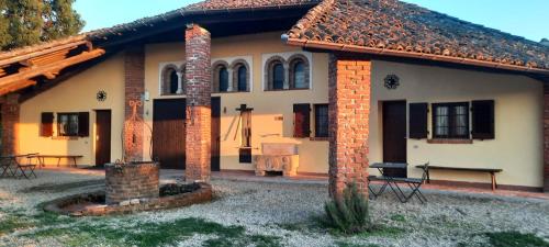 a house with a fireplace in front of it at MUSEO GAR-AgriHotel in Certosa di Pavia