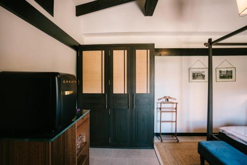 a room with a door and a tv and a ladder at Hotel Son Molí Country House in Playa de Palma