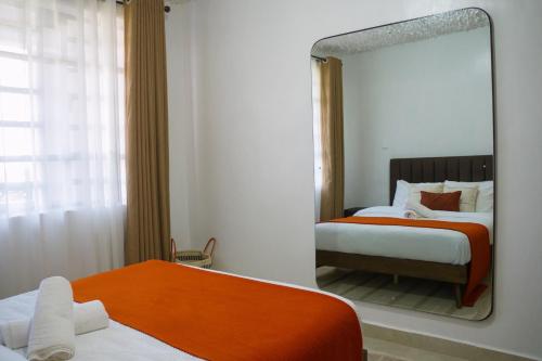 Postel nebo postele na pokoji v ubytování Nanyuki Luxe Stays