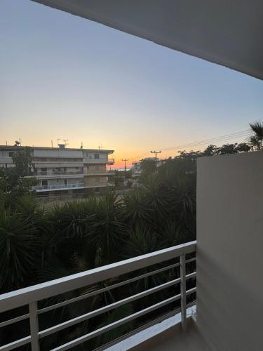 a view of the sunset from the balcony of a building at Blue Calm - Kalamos Seaside Studios in Áyioi Apóstoloi