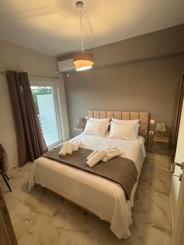 a bedroom with a bed with two towels on it at Blue Calm - Kalamos Seaside Studios in Áyioi Apóstoloi