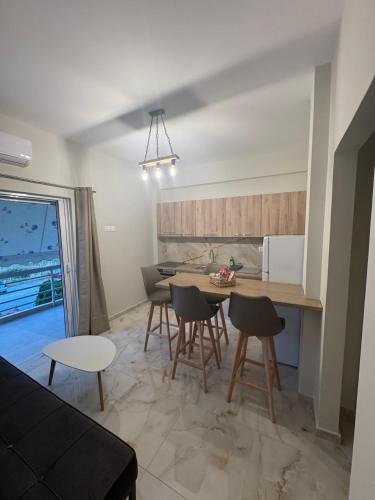a kitchen and dining room with a table and chairs at Blue Calm - Kalamos Seaside Studios in Áyioi Apóstoloi