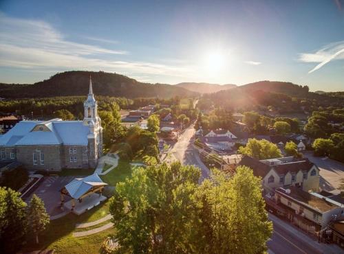 an aerial view of a small town with a church at Luxury ski-in ski-out condo in St-Sauveur 2 bedrooms in Saint-Sauveur-des-Monts