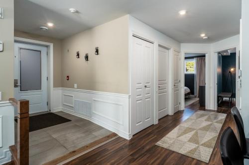 a home hallway with white walls and wood floors at Luxury ski-in ski-out condo in St-Sauveur 2 bedrooms in Saint-Sauveur-des-Monts