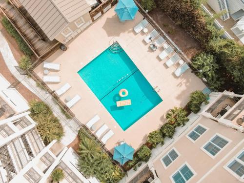 an overhead view of a pool with chairs and umbrellas at Sea Gate #102 in Saint Simons Island