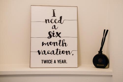 a sign that says i need a six month vacation twice a year at Villa Rae in Ostend