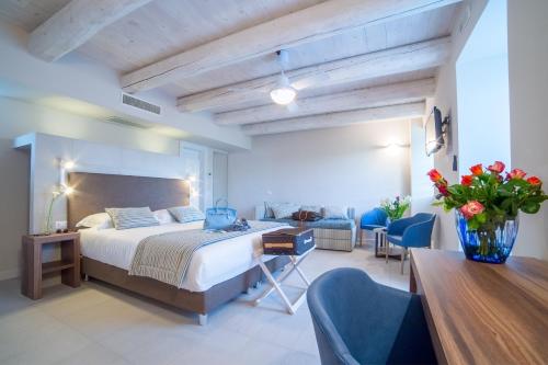 a bedroom with a bed and a desk and chairs at Agromarino in Sirolo
