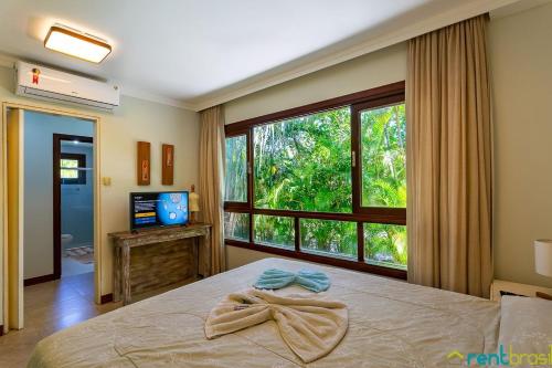 Ένα ή περισσότερα κρεβάτια σε δωμάτιο στο Reserva Imbassaí - Casa C03 Orquídeas