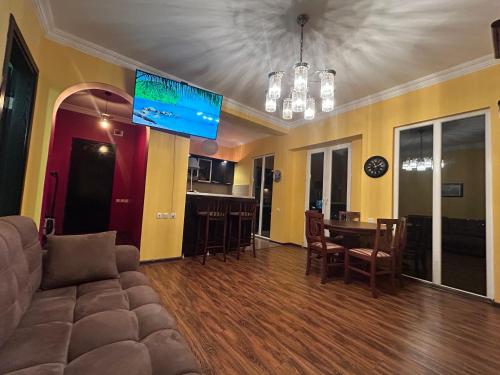 a living room with a couch and a table at Green Villa Sea View in Gonio