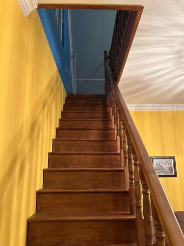 a stairway in a house with wooden stairs at Green Villa Sea View in Gonio